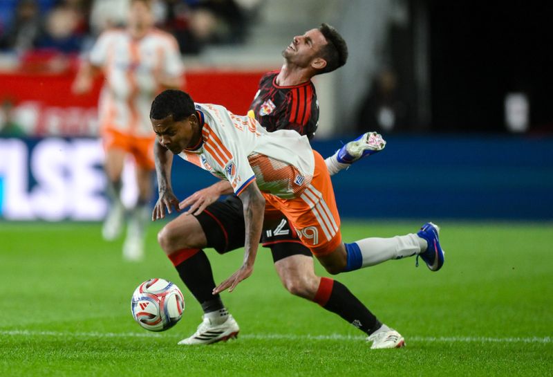 Red Bull New York defender Dylan Nealis (12) collides with FC Cincinnati forward Bryan Ramírez (29) during the first half at Sports Illustrated Stadium April 4.