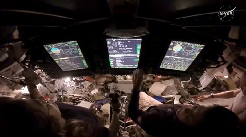 NASA astronaut Christina Koch, left, takes control of the Orion spacecraft during a manual piloting test of the Artemis II mission. To her right is CSA (Canadian Space Agency) astronaut Jeremy Hansen and NASA astronaut Victor Glover.