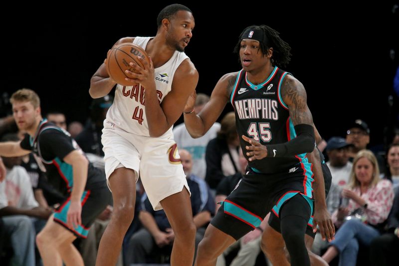 Cleveland Cavaliers center Evan Mobley (4) handles the ball as Memphis Grizzlies forward GG Jackson (45) defends April 6, 2026, in Memphis, Tennessee.