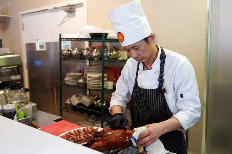 Chef Liu prepares sliced duck at Duck Beijing House, in Sharonville.