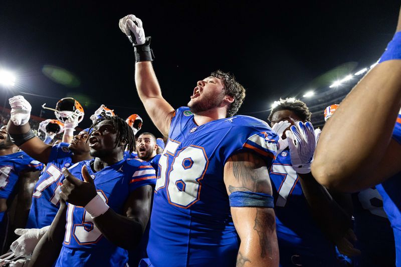 Nov 16, 2024; Gainesville, Florida, USA; Florida Gators offensive lineman Austin Barber (58) cheers with Florida Gators running back Jadan Baugh (13) after a game against the LSU Tigers at Ben Hill Griffin Stadium. Mandatory Credit: Matt Pendleton-Imagn Images