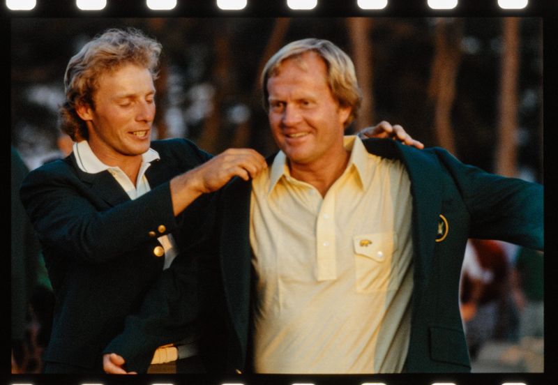 Bernhard Langer presents Jack Nicklaus with the winner's green jacket at the Augusta National Golf Course following the 1986 Masters.