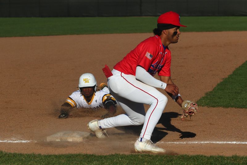 Watkins Memorial's Cam Burt slides into third base as Lakewood's Jalen White waits for the throw during the host Warriors' 11-1 victory on April 8, 2026.