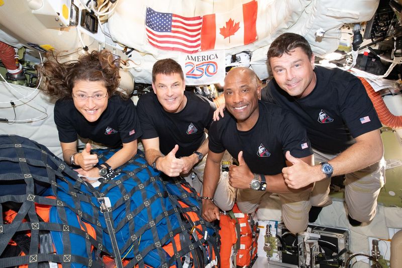 The Artemis II crew – (from left) Mission Specialist Christina Koch, Mission Specialist Jeremy Hansen, Pilot Victor Glover, and Commander Reid Wiseman – pause for a group photo inside the Orion spacecraft on their way home.