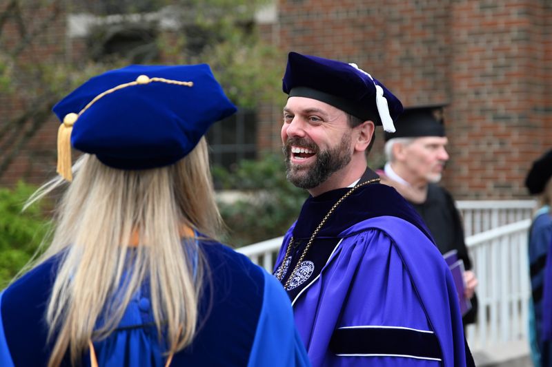 Capital University President Jared Tice speaks outside Mees Auditorium with a delegate who attended his investiture ceremony on April 10, 2026. Tice is the 18th president of Capital University.