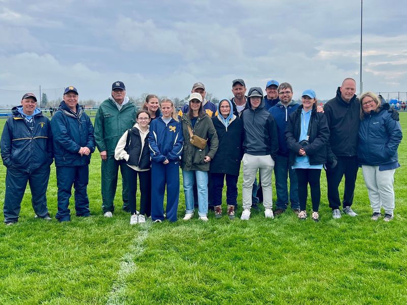 River Valley track and field coaches present and past stand alongside family members of late RV principal Ed Crawford as his memory was honored April 10, 2026, at the Keller/Rich River Valley Relays.