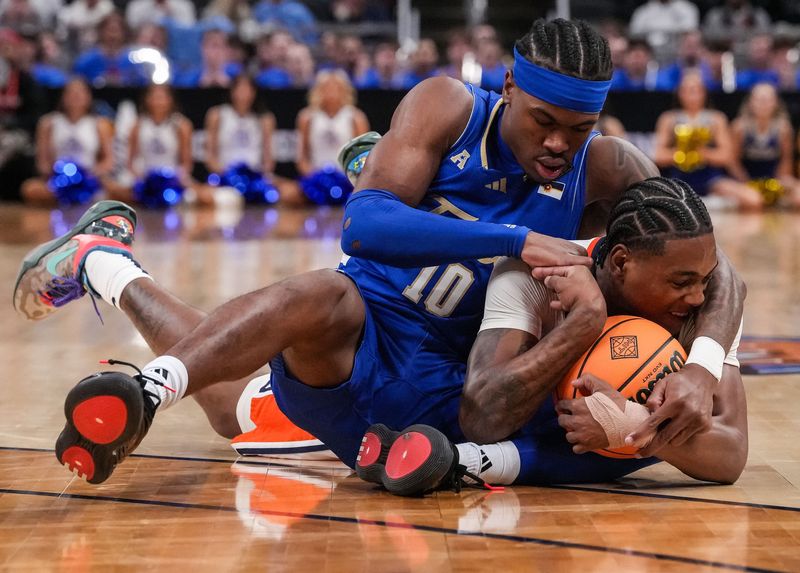 Tulsa Golden Hurricane guard Tylen Riley (10) battles for control of the ball against Auburn Tigers guard Tahaad Pettiford (0) in the NIT championship in Indianapolis April 5.