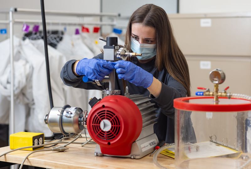 Columbus State Community College student Ava Zellers works on a device to create a vacuum in an Electro-Mechanical Technology class.