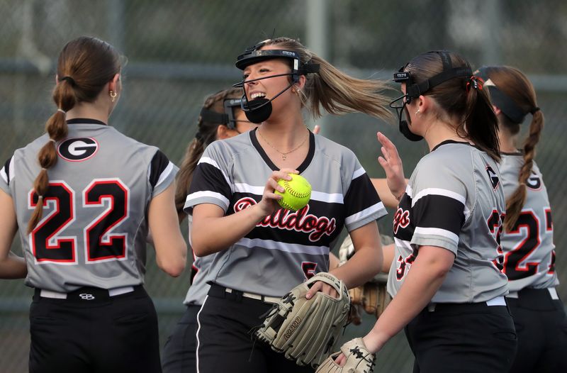 Green pitcher Hailey Yania, facing, celebrates an out with her teammates during the fourth inning of a high school softball game against Archbishop Hoban, April 13, 2026, in Akron, Ohio.