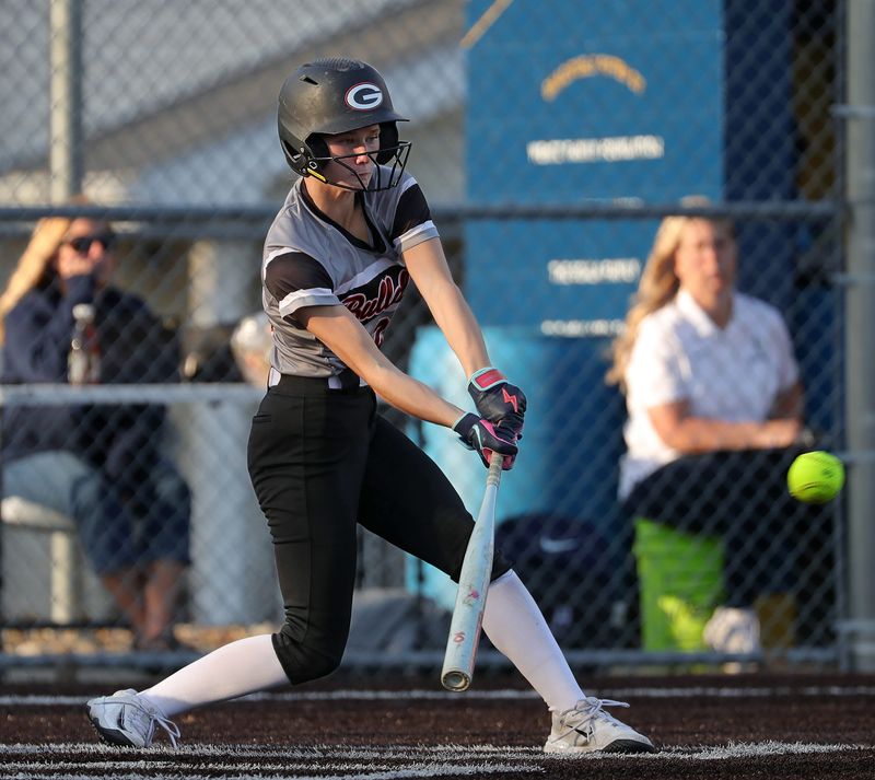 Green’s Hayden Hart connects with a pitch during the sixth inning of a high school softball game, April 13, 2026, in Akron, Ohio.