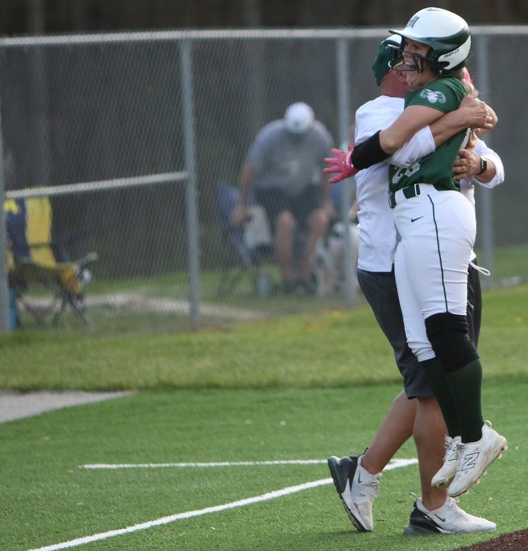 Madison's Allie Shrader jumps into the arms of coach Tim Niswander after delivering the game-winning, walk-off, RBI double in the bottom of the eighth inning of the Rams' 1-0 Ohio Cardinal Conference softball win over New Philadelphia on Tuesday, April 14, 2026.