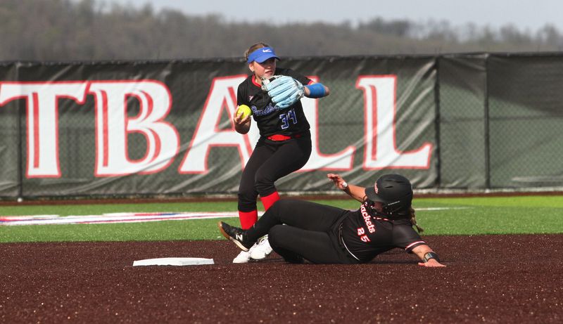 Emma Flowers attempts to turn a double play after forcing out Mount Vernon's Harley Styndl during Licking Valley's 3-2, eight-inning victory April 14 at home.