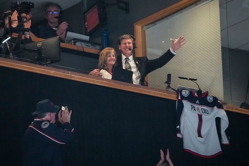 Blue Jackets public address announcer Greg Murray waves as he's recognized while calling his final game on April 14.