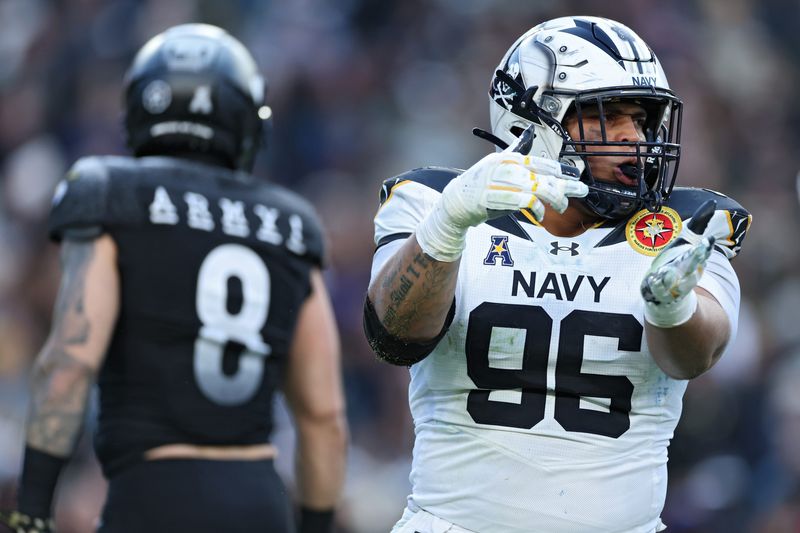 Defensive tackle Landon Robinson (96) of the Navy Midshipmen celebrates a sack against the Army Black Knights during the first half on Dec. 14, 2024 in Landover, Maryland.