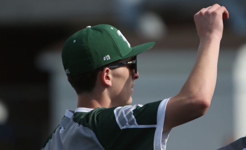 Madison's Kylor Steagall holds his hand up in the huddle while sporting the No. 19 on his cap in honor of All-Ohio player Luke Yetzer who passes away in August of 2025.