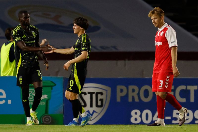 Crew forward Jamal Thiare (19) celebrates with midfielder Hugo Picard (30) after scoring a goal against the Richmond Kickers on April 15.