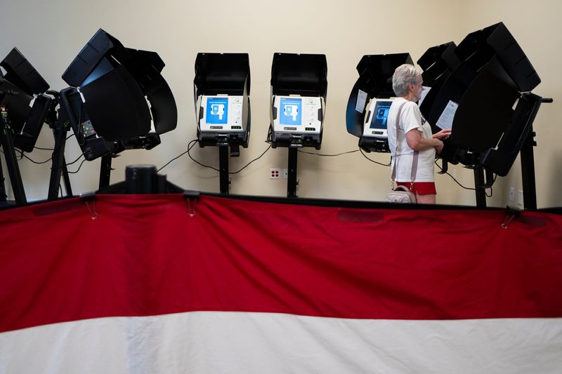 Cheryl Crawford, 76, of Clintonville, casts her vote early in the primary election during early voting at the Franklin County Board of Elections.