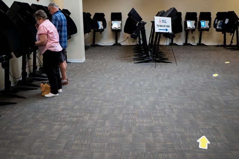 Nancy Daily, left, and Loren Daily, right, of Gahanna cast their votes early in the primary election during early voting at the Franklin County Board of Elections.