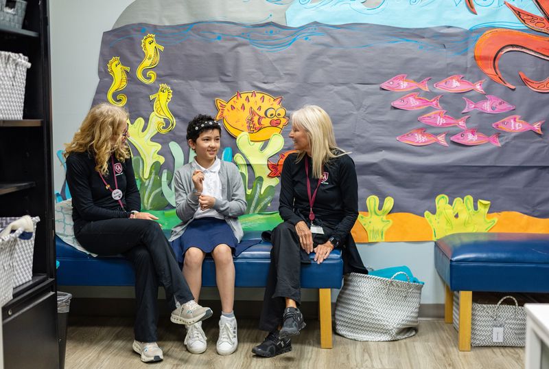 Kaia Julka, center, with school nurses Janet Fireman, left, and Beckie Hoagland at the Columbus Academy.