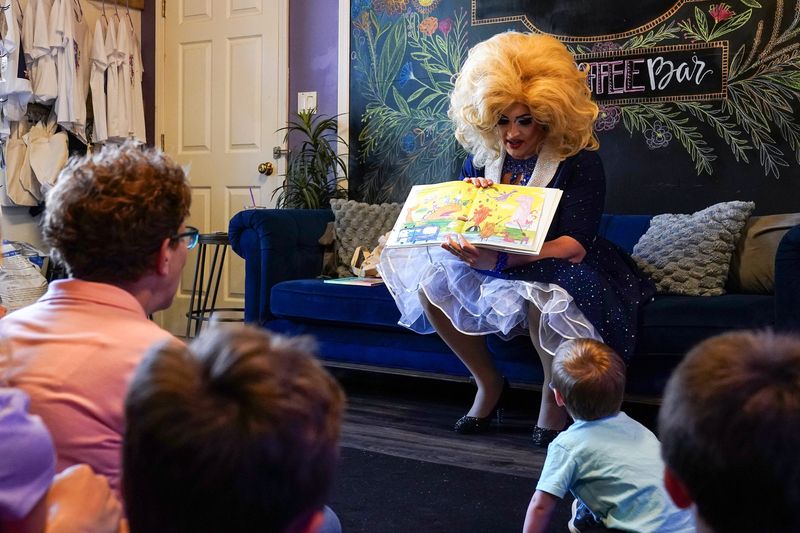 Jacob Welch, Roxie D. Mocracy in drag, reads to a group during a during a storytime event, Thursday, April 16, 2026, at Coterie Lounge & Cafe in West Chester Township.
