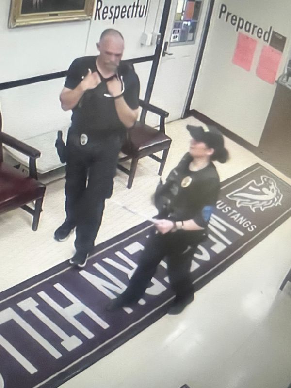Surveillance images showing Gratis police Officer Jeff Baylor and police Chief Tonina Lamanna  at Western Hills University High School on April 15