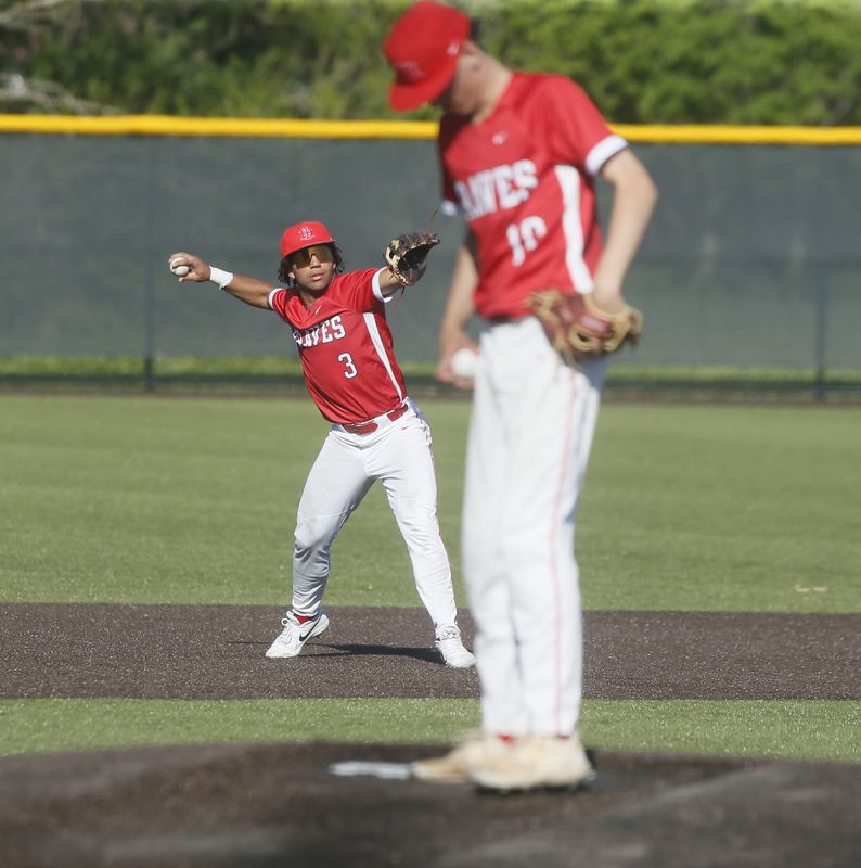 Indian Hill shortstop Devlan Daniel warms up between innings as Indian Hill defeated Batavia 9-3 in OHSAA high school baseball April 17, 2026, at Batavia.