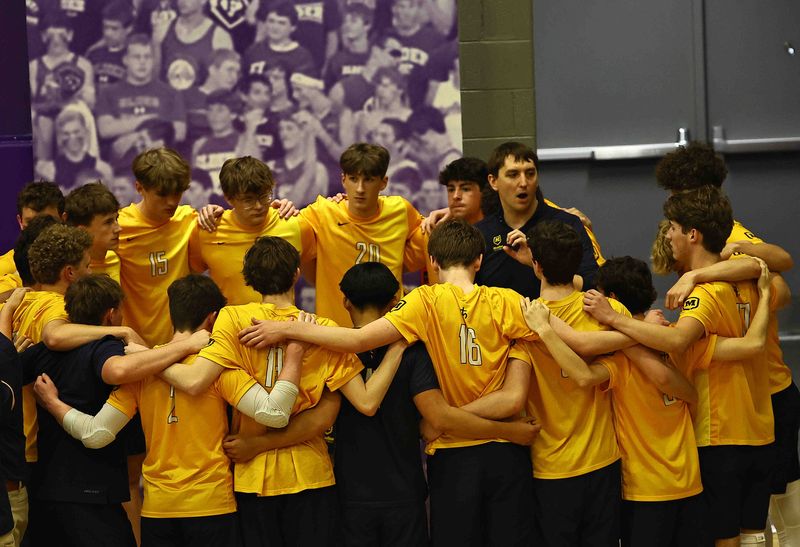 Moeller head coach Casey Pieper talks with his team before their volleyball game against Elder on Friday, April 17, 2026. Moeller beat Elder in four sets, 25-20, 25-15, 19-25, 25-19.