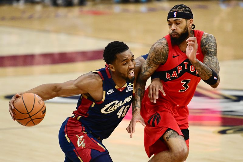 Apr 18, 2026; Cleveland, Ohio, USA; Cleveland Cavaliers guard Donovan Mitchell (45) drives to the basket against Toronto Raptors forward Brandon Ingram (3) during the first quarter of game one in the first round of the 2026 NBA Playoffs at Rocket Arena. Mandatory Credit: Ken Blaze-Imagn Images