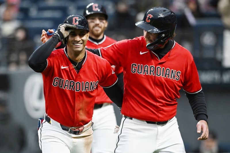 Cleveland Guardians' Brayan Rocchio. left, celebrates with teammate Rhys Hoskins, right, after hitting a three-run home run against the Baltimore Orioles on April 18, 2026, in Cleveland.
