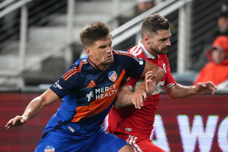 FC Cincinnati defender Nick Hagglund (4) (left) and Chicago Fire FC forward Hugo Cuypers (9) (right) compete for position during the second half of an MLS match at TQL Stadium.