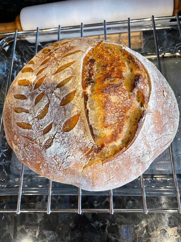 A loaf of baked sourdough bread.