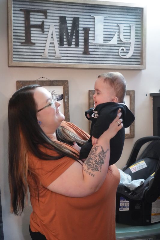 Abby Schafer, plays with her son Everett Robinson at their Perry Township home.