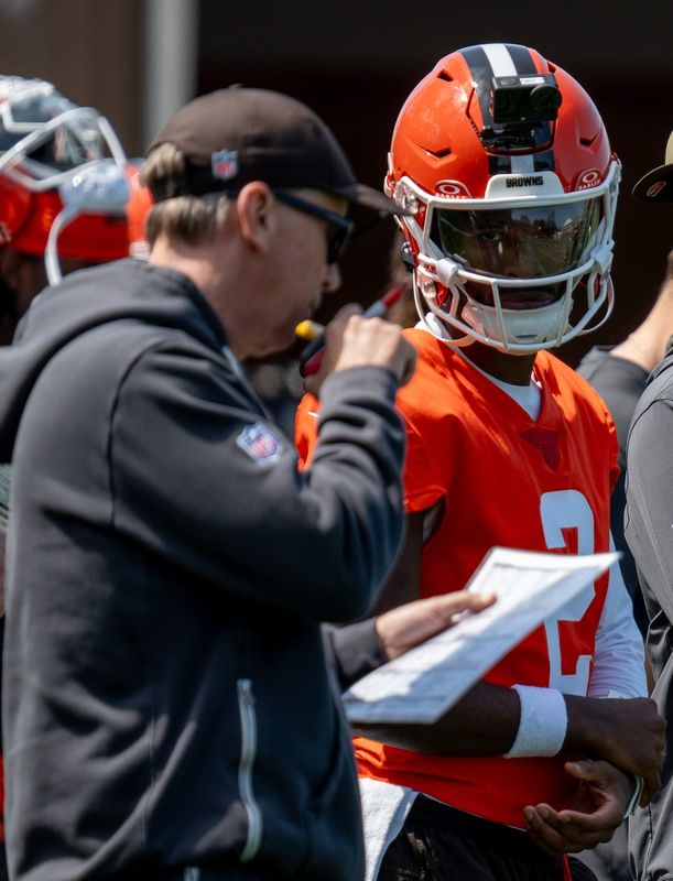 Browns quarterback Shedeur Sanders watches as head coach Todd Monken speaks on the radio during a 7-on-7 training session at minicamp, April 21, 2026, in Berea.