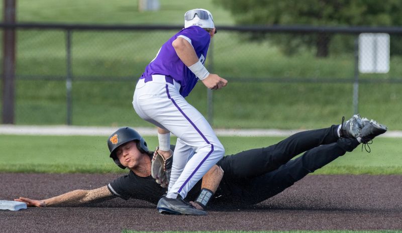 Hoover’s Ryan Cervenak is tagged out by Jackson’s Lucas Yoder on Tuesday, April 21, 2026. Bob Rossiter / Special To The Canton Repository