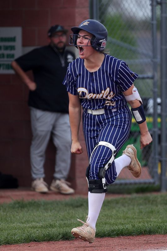Tallmadge’s Sophia Paonessa celebrates as she runs home after hitting a homer during the fifth inning of a high school softball game, April 22, 2026, in Aurora, Ohio.