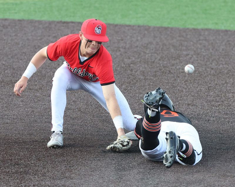 McKinley’s Mike Martin can’t come up with the tag at second as Massillon’s Isaac Maxheimer is safe in the third inning at Munson Stadium. Wednesday, April 22, 2026.