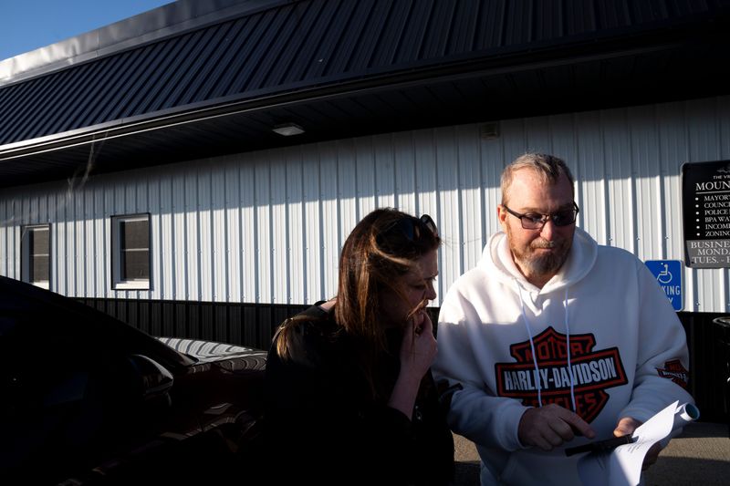 Residents in Mount Orab chat about data centers outside a village council meeting.