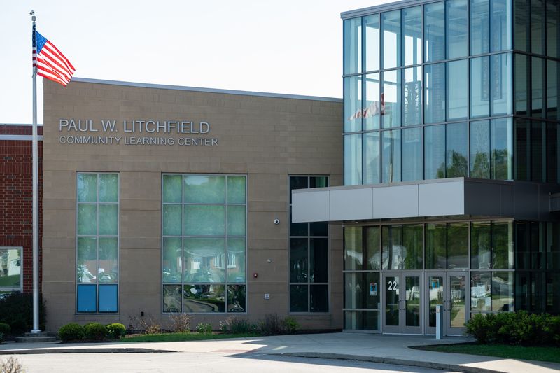 Akron police are looking into a report of a boy handing out counterfeit $20 bills at Litchfield Community Learning Center.