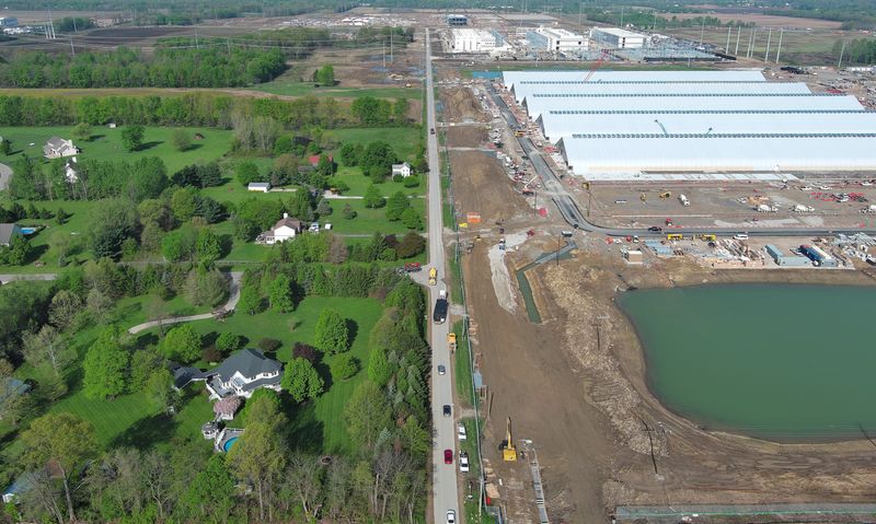 Miller Road, seen here April 24, is the line of separation between long-standing residential and the data center boom taking over the New Albany community. At left is the Bermuda Drive development, and at right is a data center being built so quickly that it does not have real walls, just a tent-like structure surrounding the computer servers. There are no signs denoting which company will be using these servers, but a similar set of buildings in the area has been identified as a Meta facility.