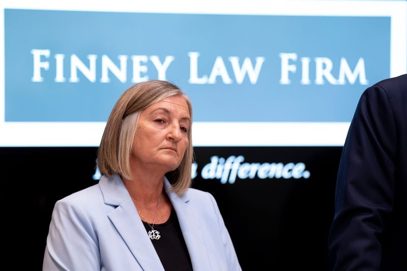 Police Chief Teresa Theetge stands with Cincinnati Employment Attorney Stephen Imm at the Finney Law Firm in Cincinnati on Friday, April 24.