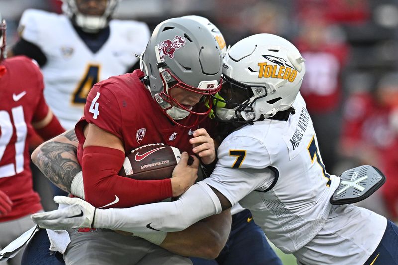 Washington State Cougars quarterback Zevi Eckhaus is tackled by Toledo Rockets safety Emmanuel McNeil-Warren in the second half, Oct. 25, 2025, in Pullman, Washington.