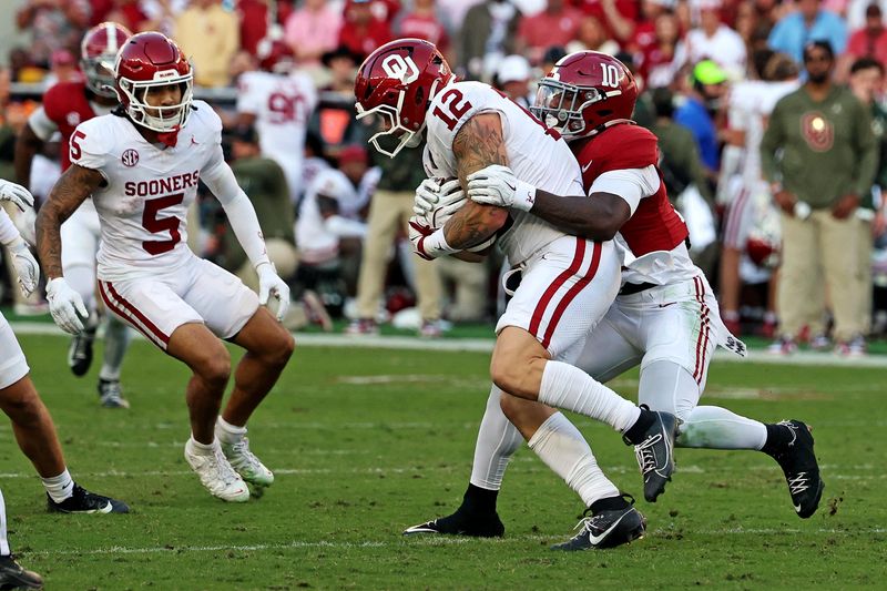 Nov 15, 2025; Tuscaloosa, Alabama, USA; Oklahoma Sooners tight end Jaren Kanak (12) is tackled by Alabama Crimson Tide linebacker Justin Jefferson (10) during the first half at Saban Field at Bryant-Denny Stadium. Mandatory Credit: David Leong-Imagn Images