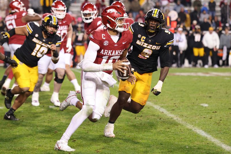 Nov 29, 2025; Fayetteville, Arkansas, USA; Arkansas Razorbacks quarterback Taylen Green (10) rushes against Missouri Tigers defensive end Zion Young (9) during the fourth quarter at Donald W. Reynolds Razorback Stadium. Missouri won 31-17. Mandatory Credit: Nelson Chenault-Imagn Images