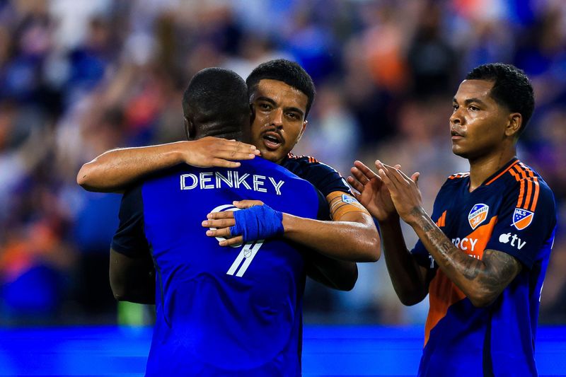 FC Cincinnati forward Kevin Denkey (9) hugs midfielder Evander (10) after scoring on a penalty kick in the first half against Red Bull New York at TQL Stadium.