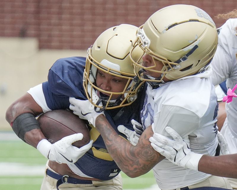 Akron Zips running back Sean Patrick is stopped by defensive back Mehki Flowers during UA's Spring Showcase on April 25, 2026, in Akron.