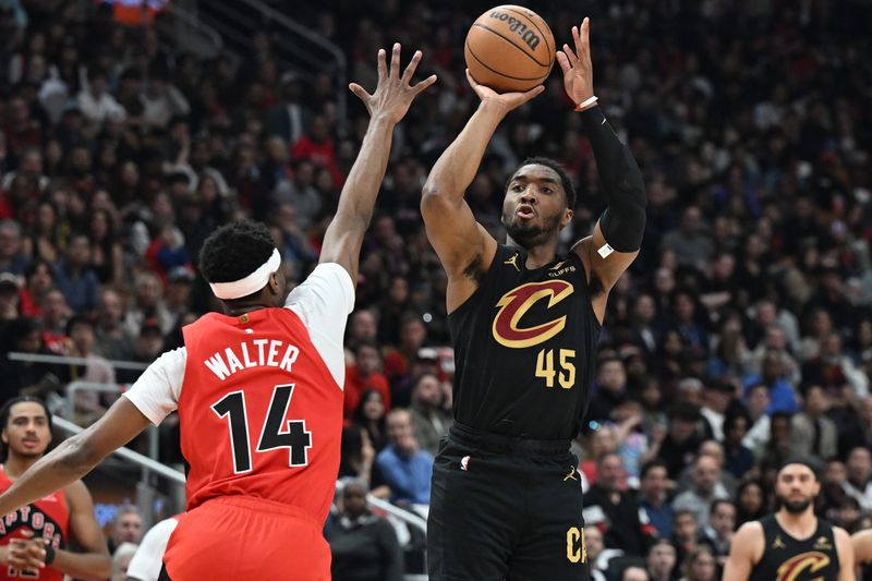 Cleveland Cavaliers guard Donovan Mitchell (45) shoots the ball over Toronto Raptors guard Ja'Kobe Walter (14) during Game 4 of an NBA first-round playoff series April 26, 2026, in Toronto, Ontario.