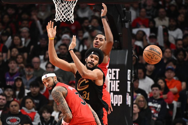 Cleveland Cavaliers center Jarrett Allen (31) loses the ball in a battle with Toronto Raptors forwards Brandon Ingram, left, and Collin Murray-Boyles during Game 4 of an NBA first-round playoff series April 26, 2026, in Toronto, Ontario.