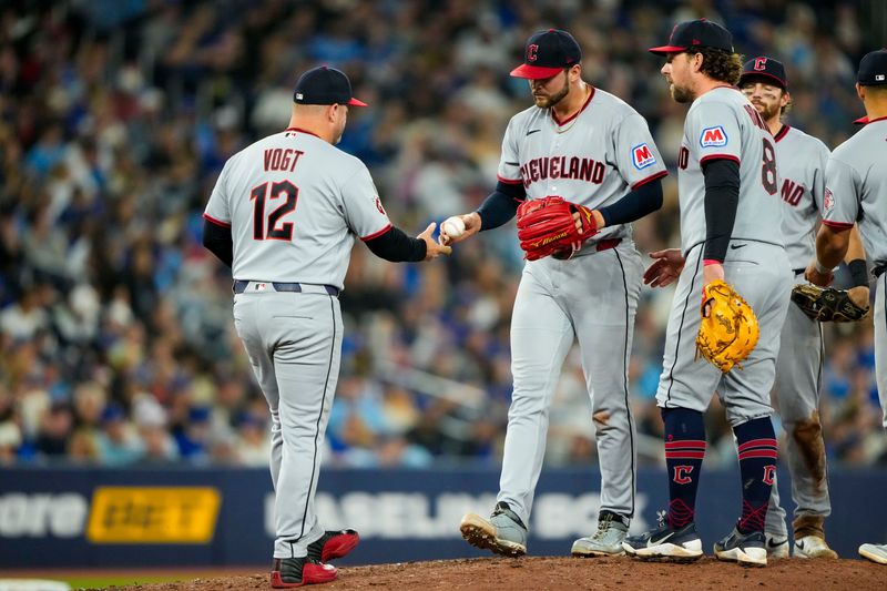 Cleveland Guardians pitcher Slade Cecconi is relieved by manager Stephen Vogt (12) during the sixth inning against the Toronto Blue Jays on April 26, 2026, in Toronto, Ontario.
