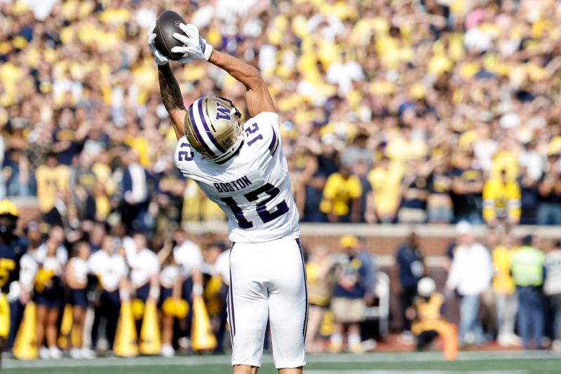 Oct 18, 2025; Ann Arbor, Michigan, USA; Washington Huskies wide receiver Denzel Boston (12) makes a reception in the first half against the Michigan Wolverines at Michigan Stadium. Mandatory Credit: Rick Osentoski-Imagn Images