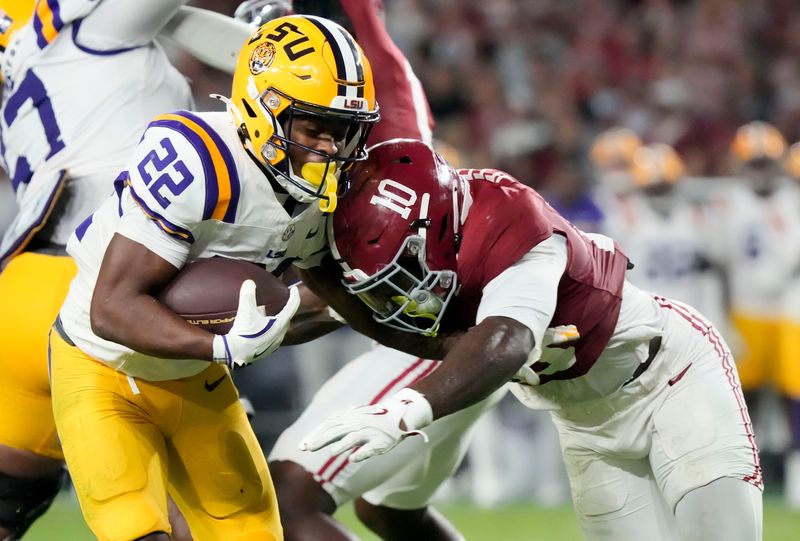 Nov 8, 2025; Tuscaloosa, Alabama, USA; Alabama linebacker Justin Jefferson (10) hits LSU running back Harlem Berry (22) at Saban Field at Bryant-Denny Stadium. Alabama defeated LSU 20-9. Mandatory Credit: Gary Cosby Jr.-Imagn Images